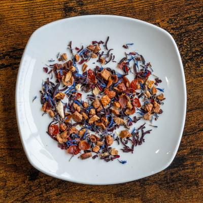 Dried herbs and flowers on a white plate.