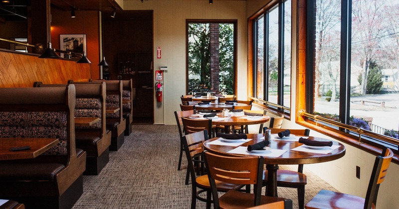 Interior, tables by the window set for guests
