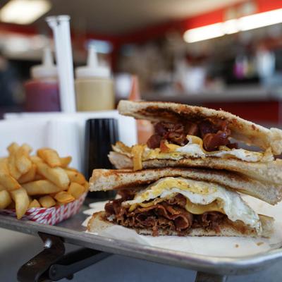 bacon egg and cheese sandwich with fries.