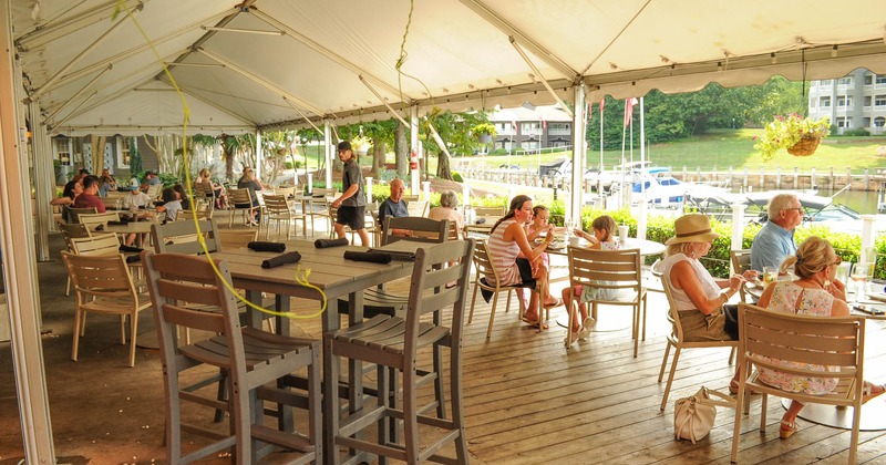 Exterior, tent covered seating area with guests dining