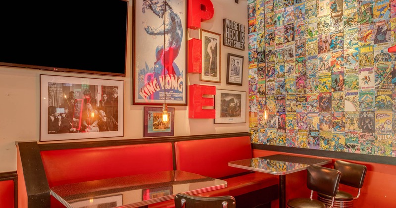 Dining tables, wall decorated with comic books