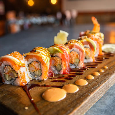 A board with sushi rolls with colorful ingredients