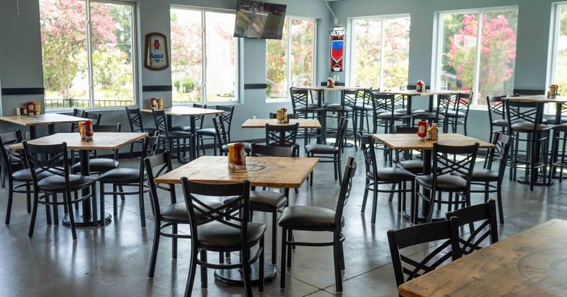 Interior, dining area, wooden top tables for four, high seating tables in the back