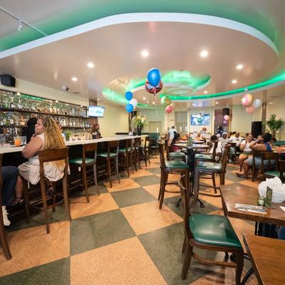 Restaurant bar and dining area with festive balloon decorations.