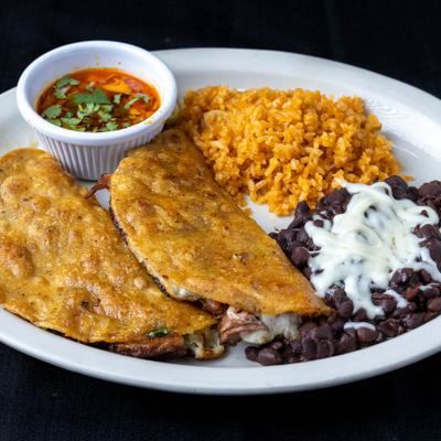 Quesabirria plate with rice, black beans, and dipping broth.