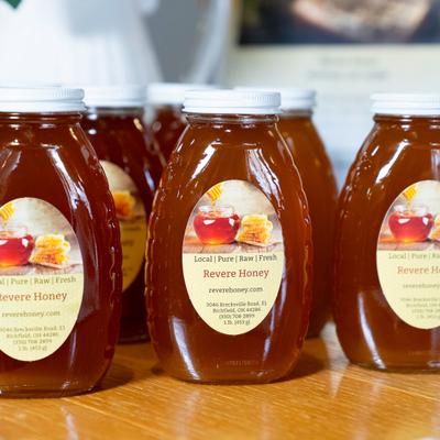 Revere Honey bottles lined up on a table.