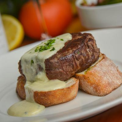 Filet mignon in a brandy and green peppercorn sauce served on toasted bread.
