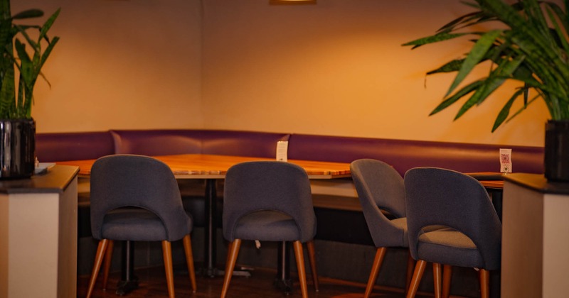 Interior, seating area, leather banquette seating, tables and chairs
