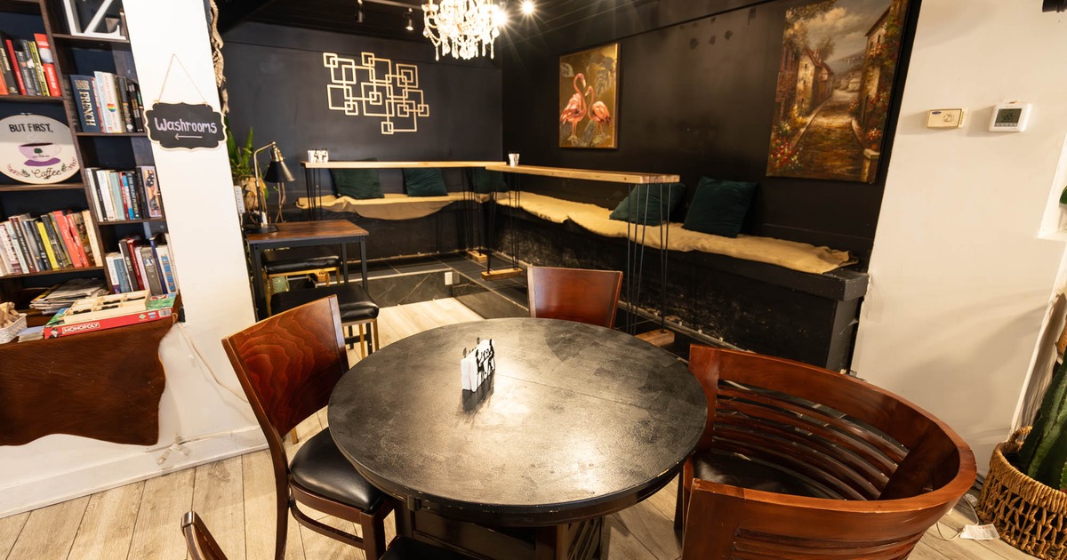 Interior, seating area, wooden top table for four, high corner banquette bench with tables