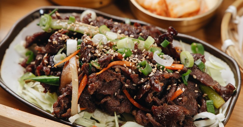 Beef Bulgogi garnished with chopped green onion and sesame seeds