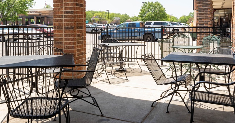 Outside, covered seating are with tables and chairs