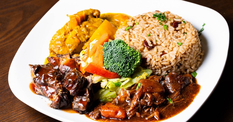 Jerk chicken, coconut curry chicken, Fricassee chicken, rice, and veggies