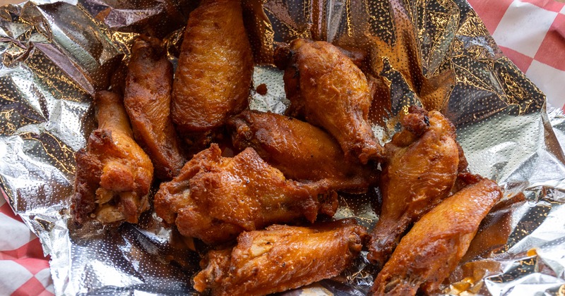 Fried chicken wings on foil