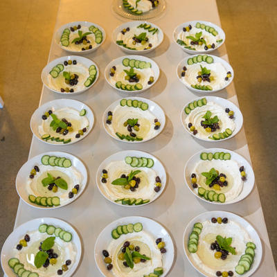 Table settings, plates of white sause whit cucumber