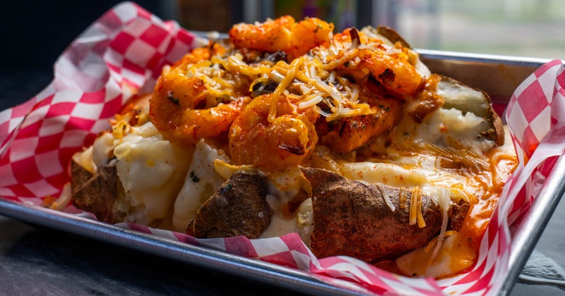 Blackened salmon, roasted shrimp, grilled onions, cheese, garlic butter, and Alfredo sauce