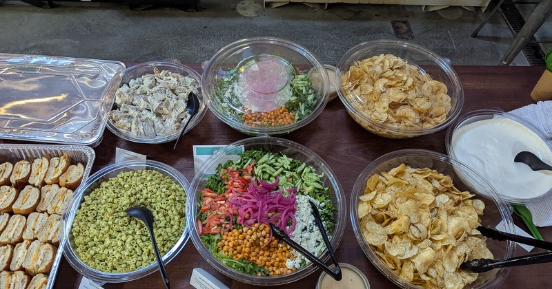 Food in various serving containers on a table