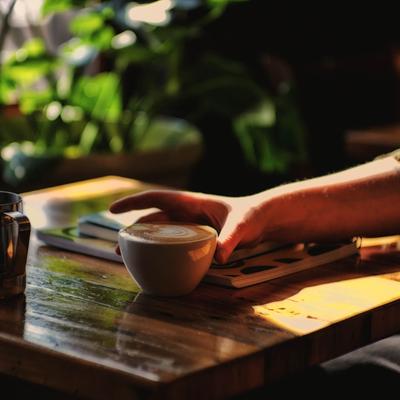 A hand holding a cup of coffee.