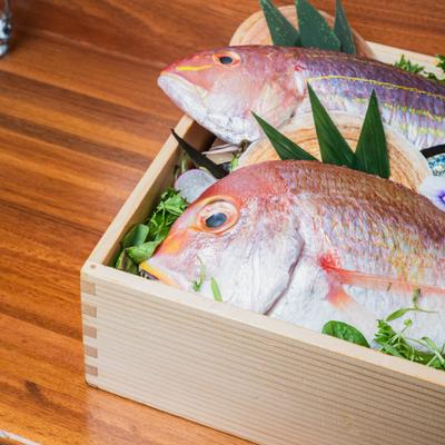 Wooden box containing fresh fish and seafood.