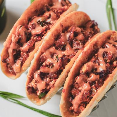 Crispy Wonton Tacos Paneer, with sweet chili sauce.