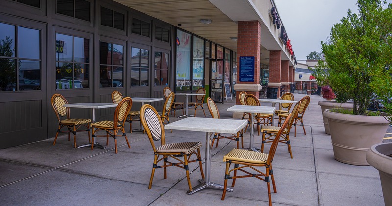 Outdoor seating area in front of the restaurant's entrance