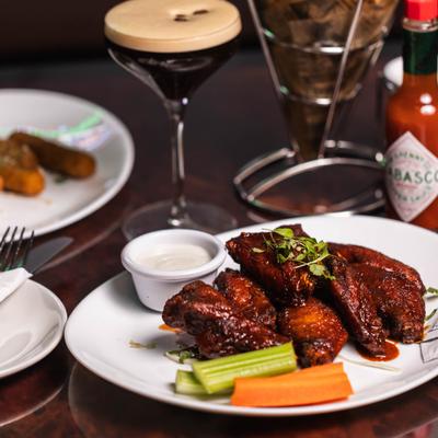 Nashville hot chicken wings with carrots, celery, ranch dipping sauce, and espresso martini.