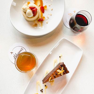 Dessert dishes with cocktails beside, top view