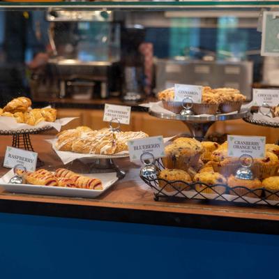 Interior, a display case filled with assorted pastries with labels.