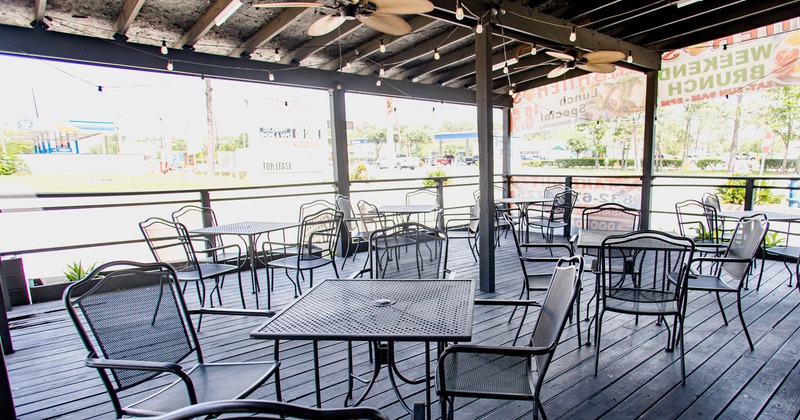 Exterior, covered patio, empty tables and chairs waiting for guests