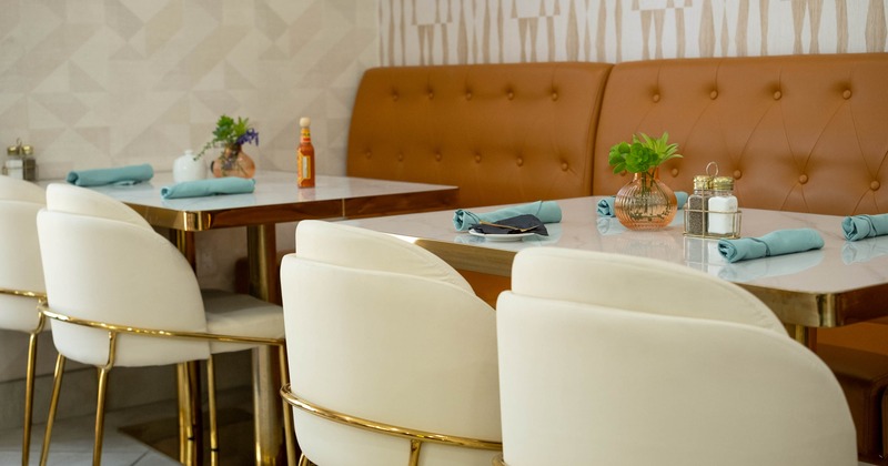 Interior, dining area, closeup on a tables with banquette bench and chairs