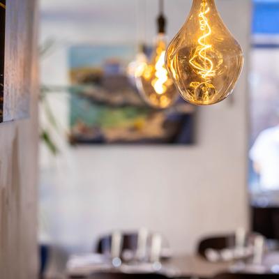 Pendant lights featuring amber-tinted glass and warm spiral filament bulb.