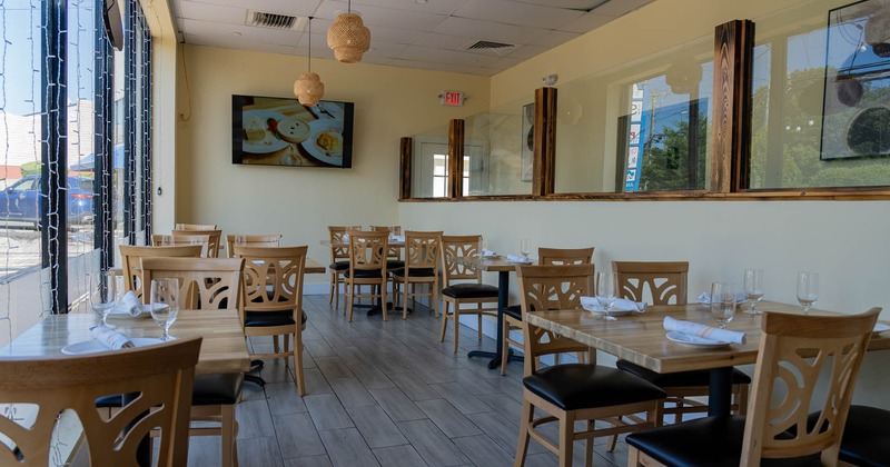 Interior, dining area, wooden tables and chairs, tile flooring, TV on the wall