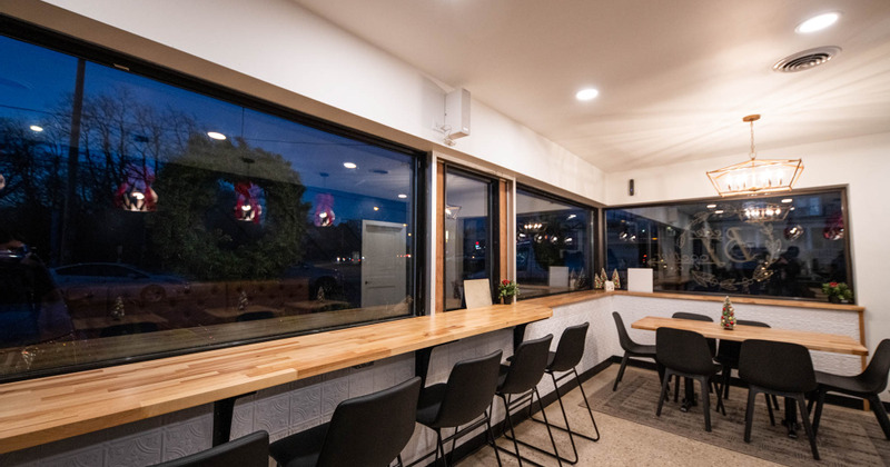 Interior, regular table for six, high seating table with stools, large window area