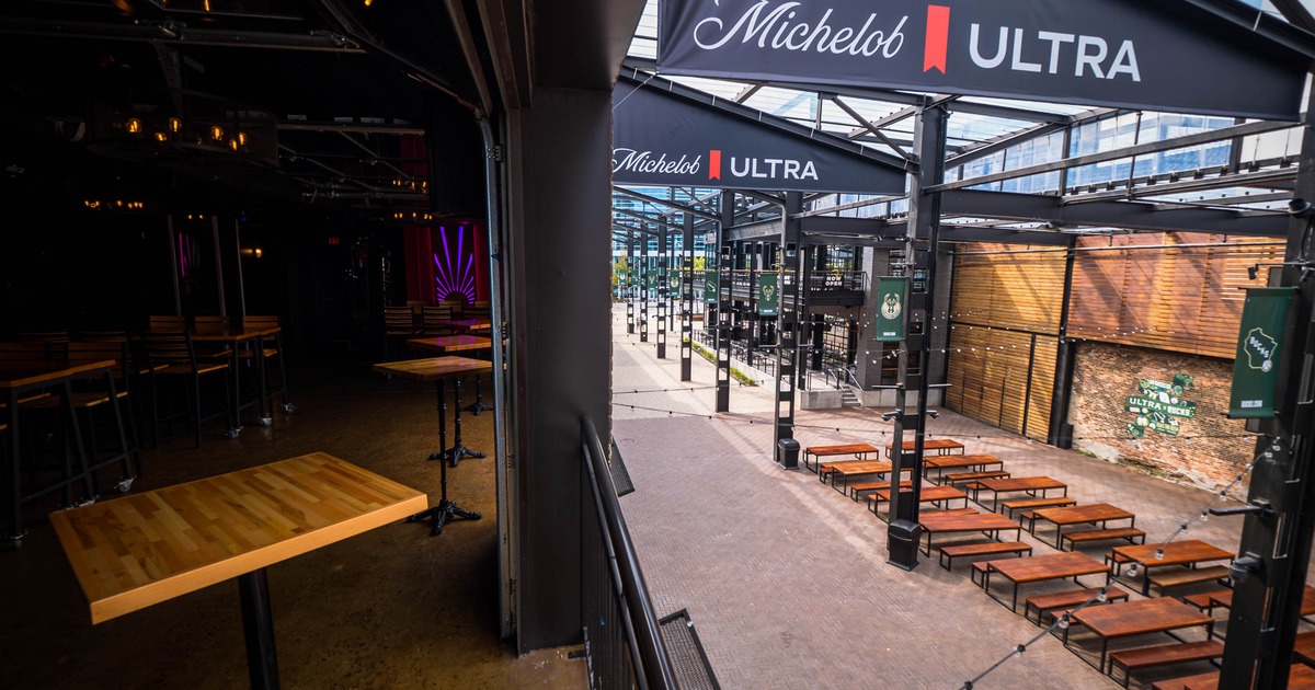 Indoor and outdoor seating areas of an entertainment venue