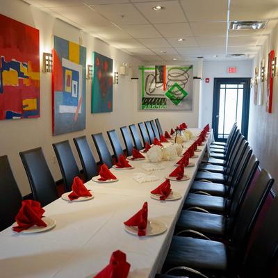 Interior, dining area, joined tables, paintings on the wall