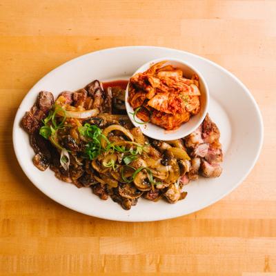 Kalua pork with kimchi and sautéed vegetables, overhead view.