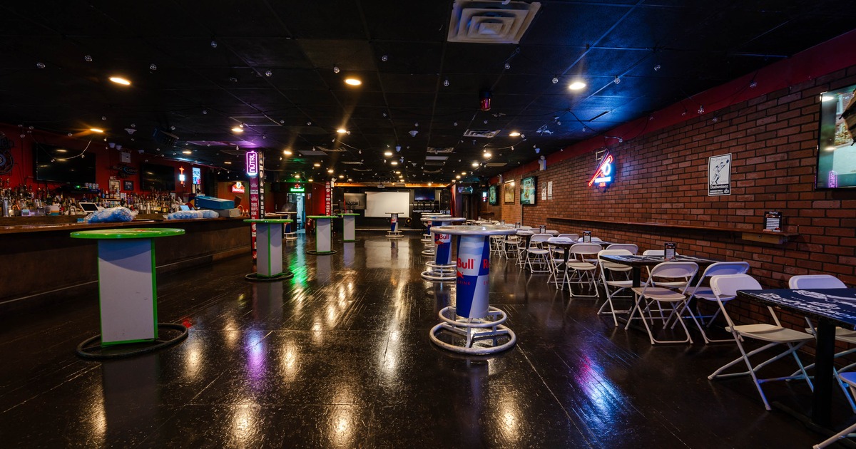 Interior - a glossy floor, colorful neon lights and seating areas with tables and chairs