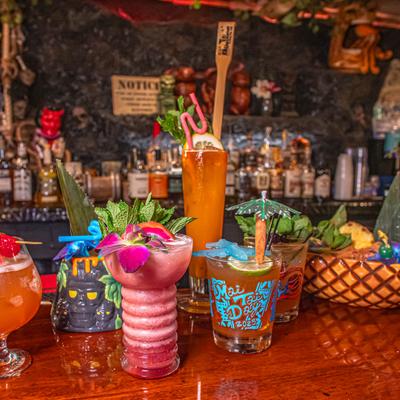 Colorful tiki cocktails on a bar counter.