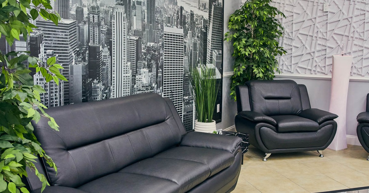 Black leather armchair and sofa, large black and white wall picture of New York