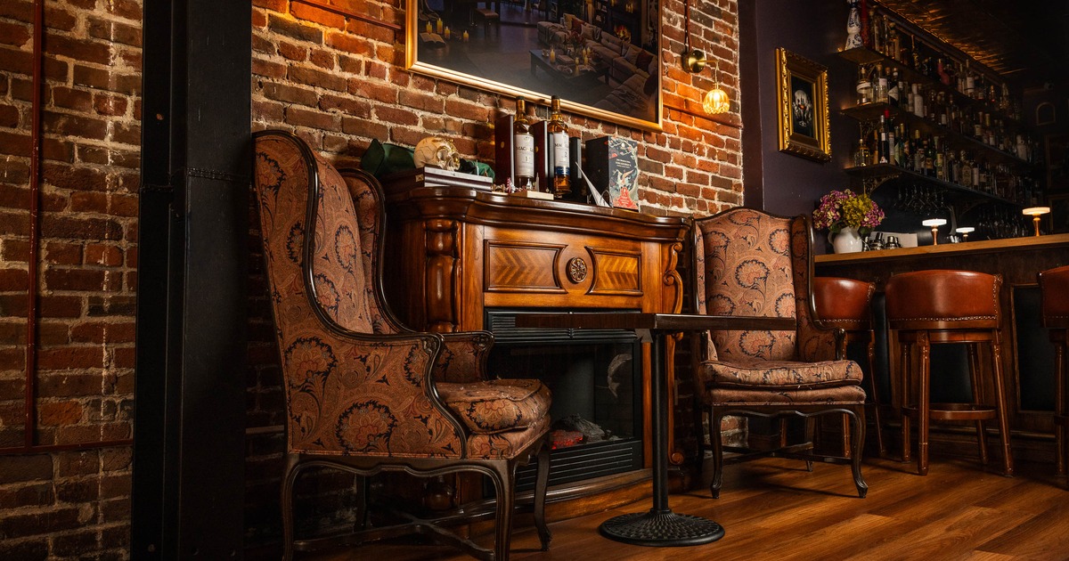 Interior, armchairs and table near fireplace