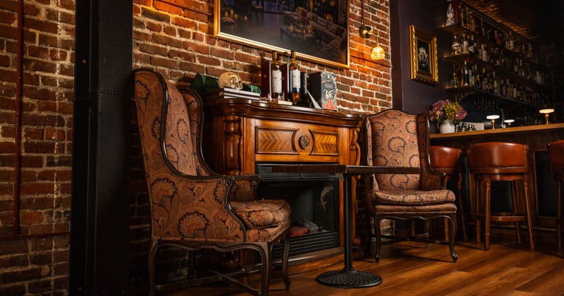 Interior, armchairs and table near fireplace