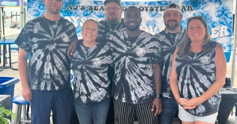 Group of employees that worked a special event showing award.