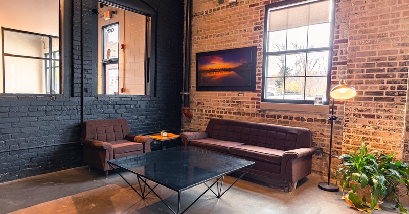 Interior, table, upholstered sofas, windows, painting, lighting