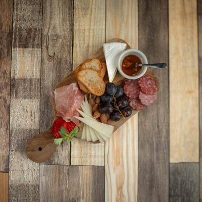 Charcuterie board with a selection of cured meats and other items.