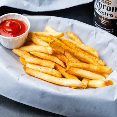 Basket of fries with ketchup.