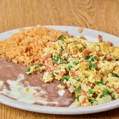 Scrambled eggs with tomatoes, onions and jalapenos, served with rice and beans.
