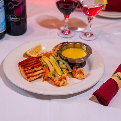 Grilled salmon, shrimp, and scallops, with veggies.