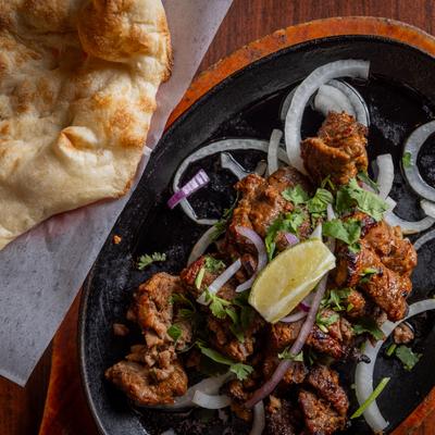 Beef Bihari Kebab and naan bread on the side.