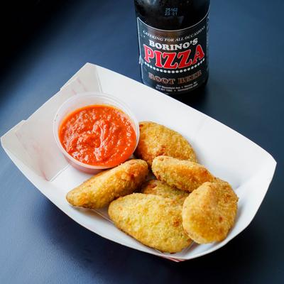 Jalapeno Poppers with a sauce and a soda drink.