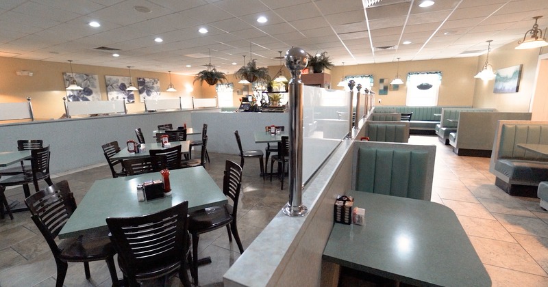 Diner area, half room with tables and chairs, galf with booths