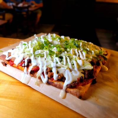 Flatbread toped with ground beef, chorizo, mozzarela, scallions and sour cream.
